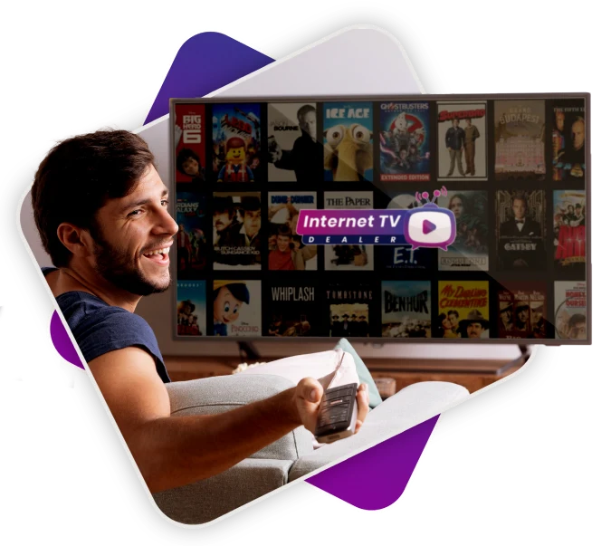 A man holding a remote control in front of a TV